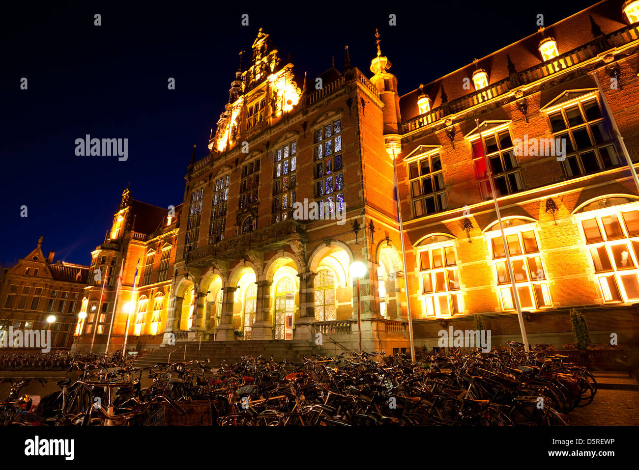 bicycles parking by University of Groningen at night, Netherlands Stock Photo