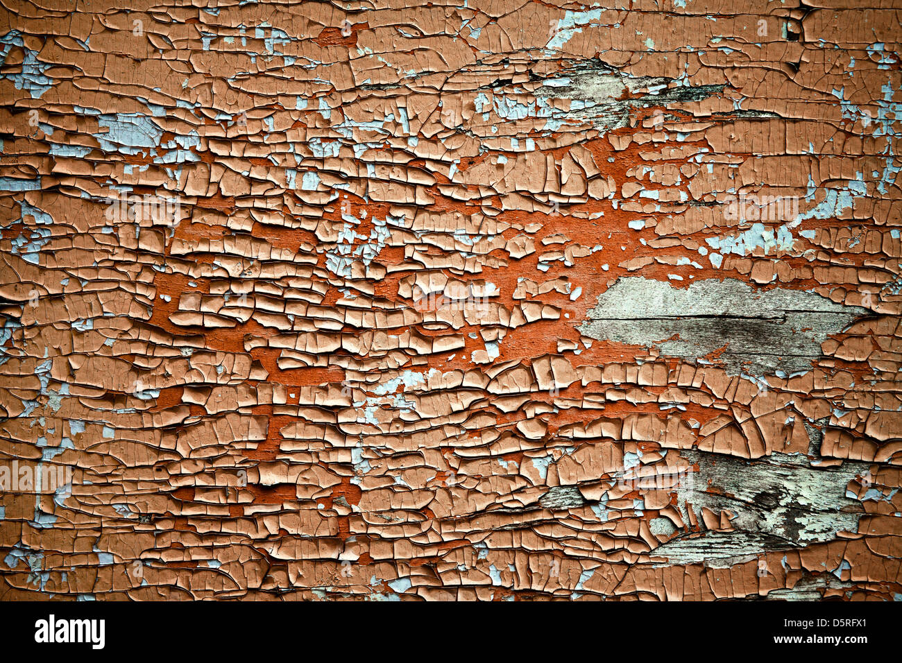 Brown rusty metal sheet with peeling black paint surface texture