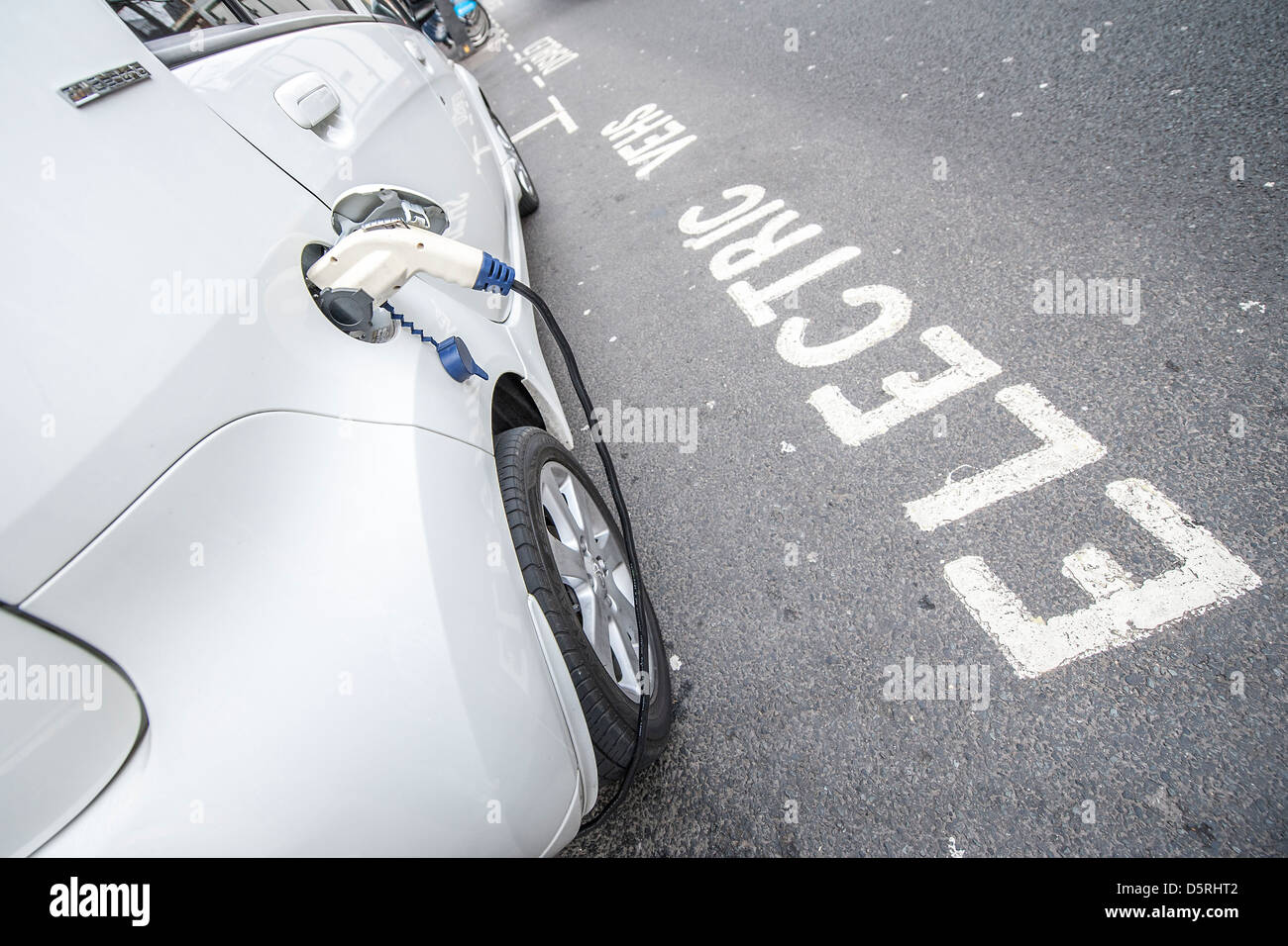 An electric car is charged outside the Department for Transport, Horseferry Road, London, UK 08 April 2013 Stock Photo