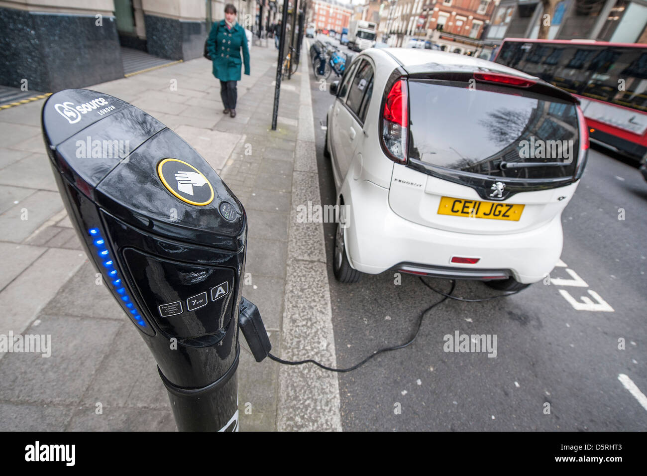 An electric car is charged outside the Department for Transport, Horseferry Road, London, UK 08 April 2013 Stock Photo