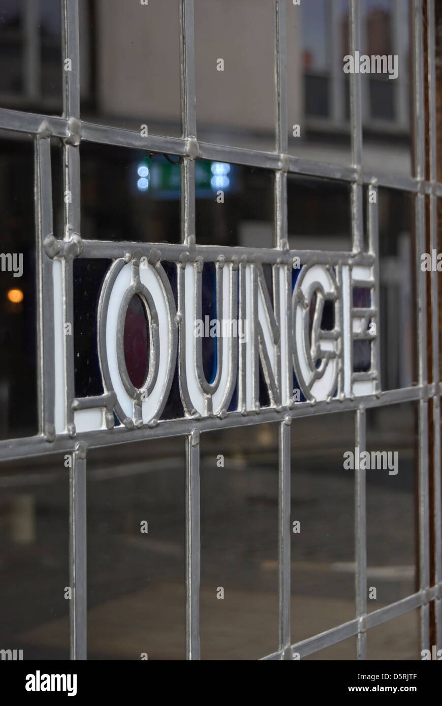 the word lounge set into a leaded light window on a door leading to the