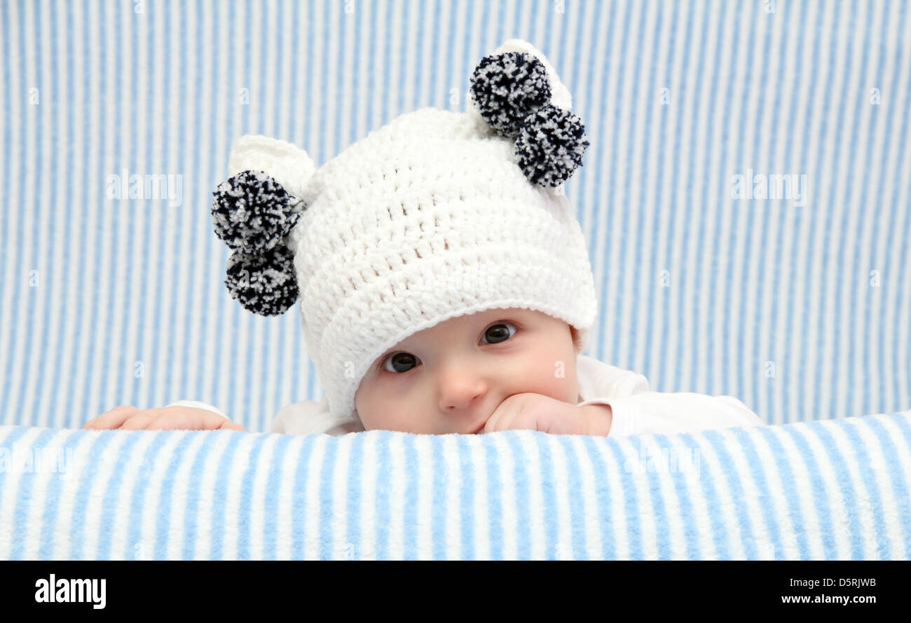 Baby with a knitted white hat Stock Photo