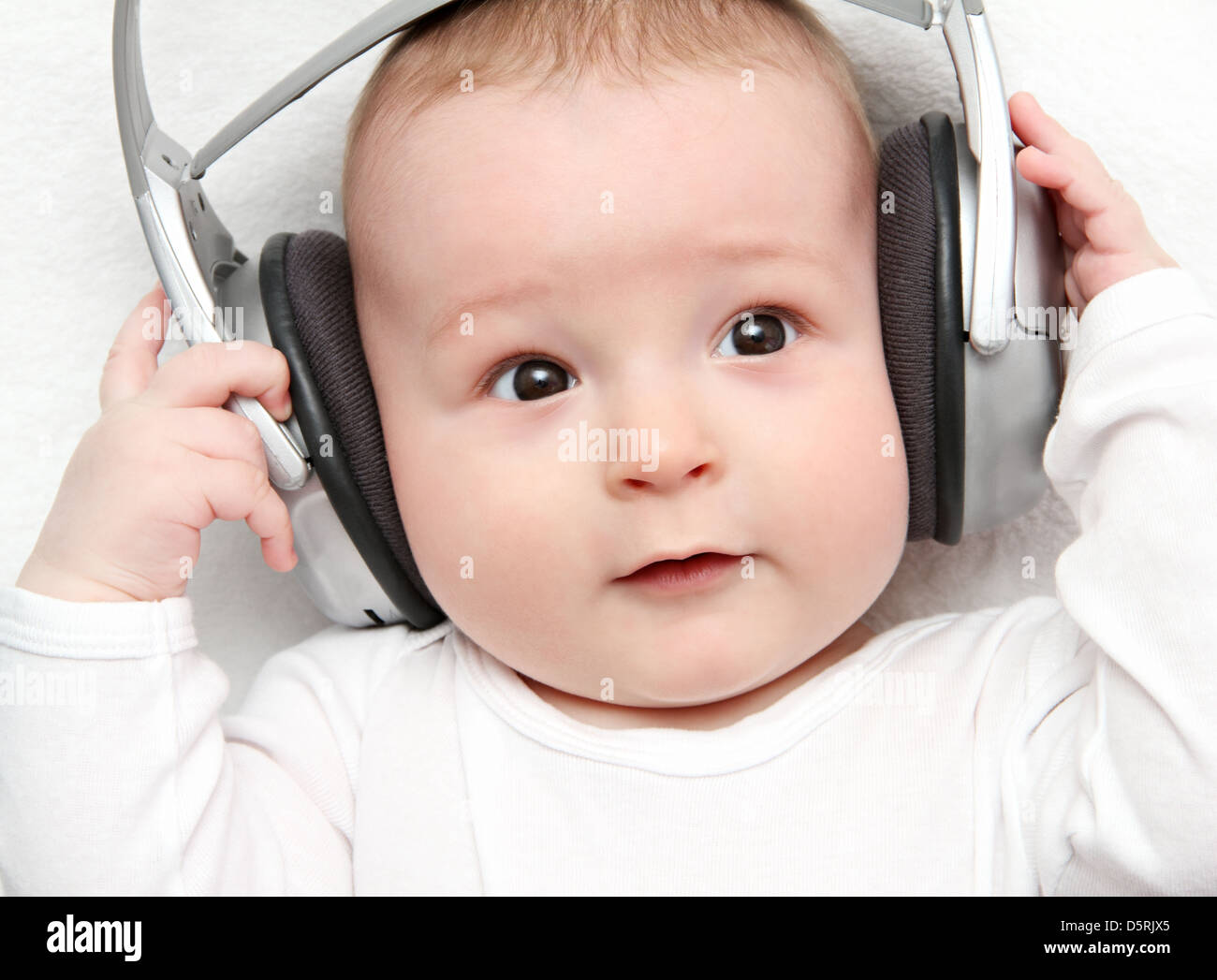 baby listening music on back Stock Photo