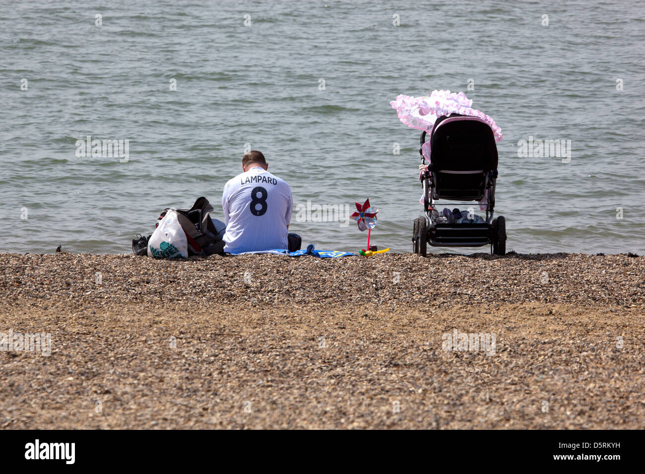 Dad with Football shirt on beach at Southend Stock Photo
