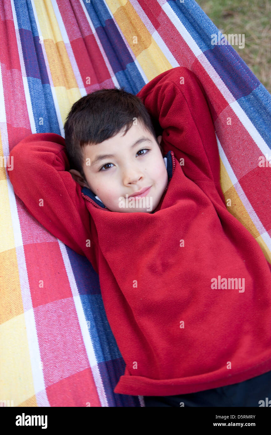 Boy lays down on hammock Stock Photo Alamy
