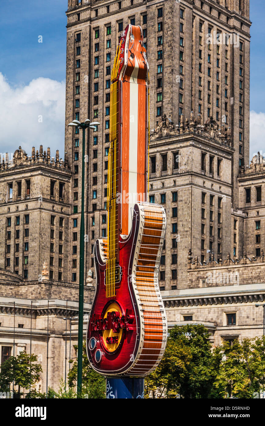 Two iconic symbols, the Palace of Culture and Science, and the Hard Rock Cafe guitar at Zlote Tarasy in Warsaw, Poland. Stock Photo