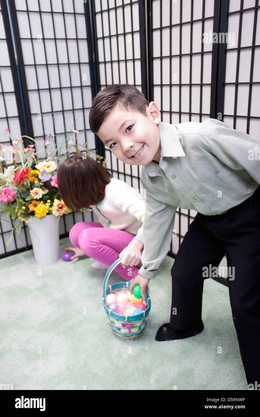 Boy snatches egg from basket. Stock Photo