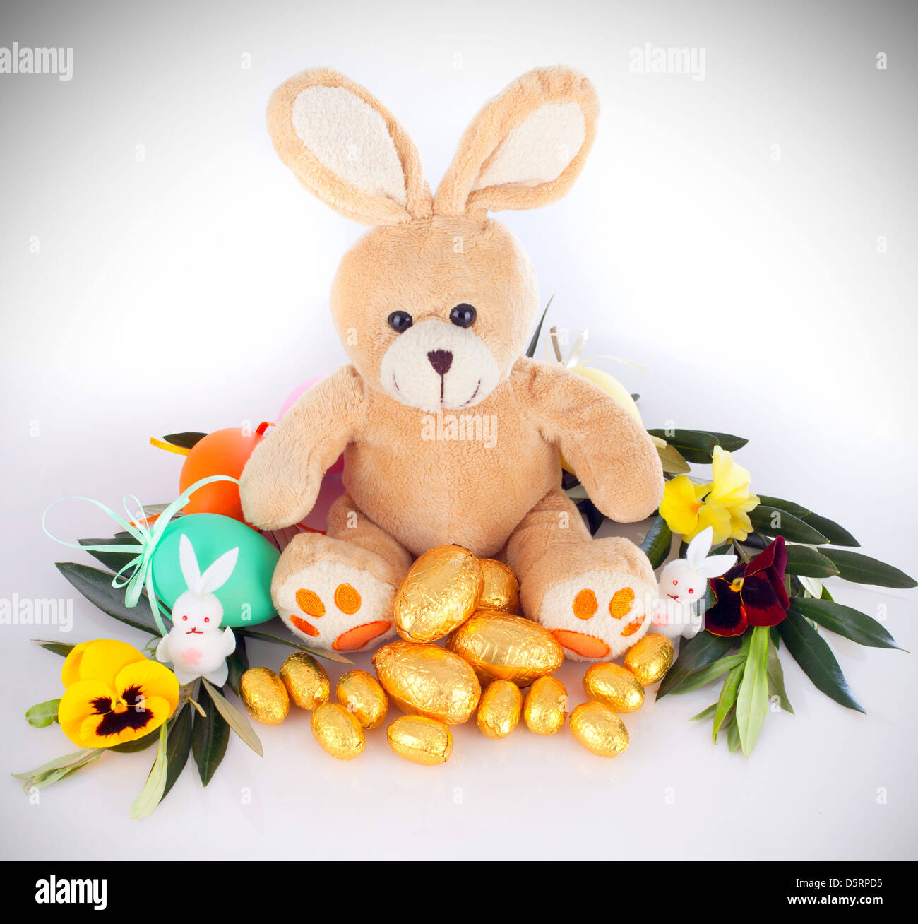 Plush bunny with chocolate eggs Stock Photo