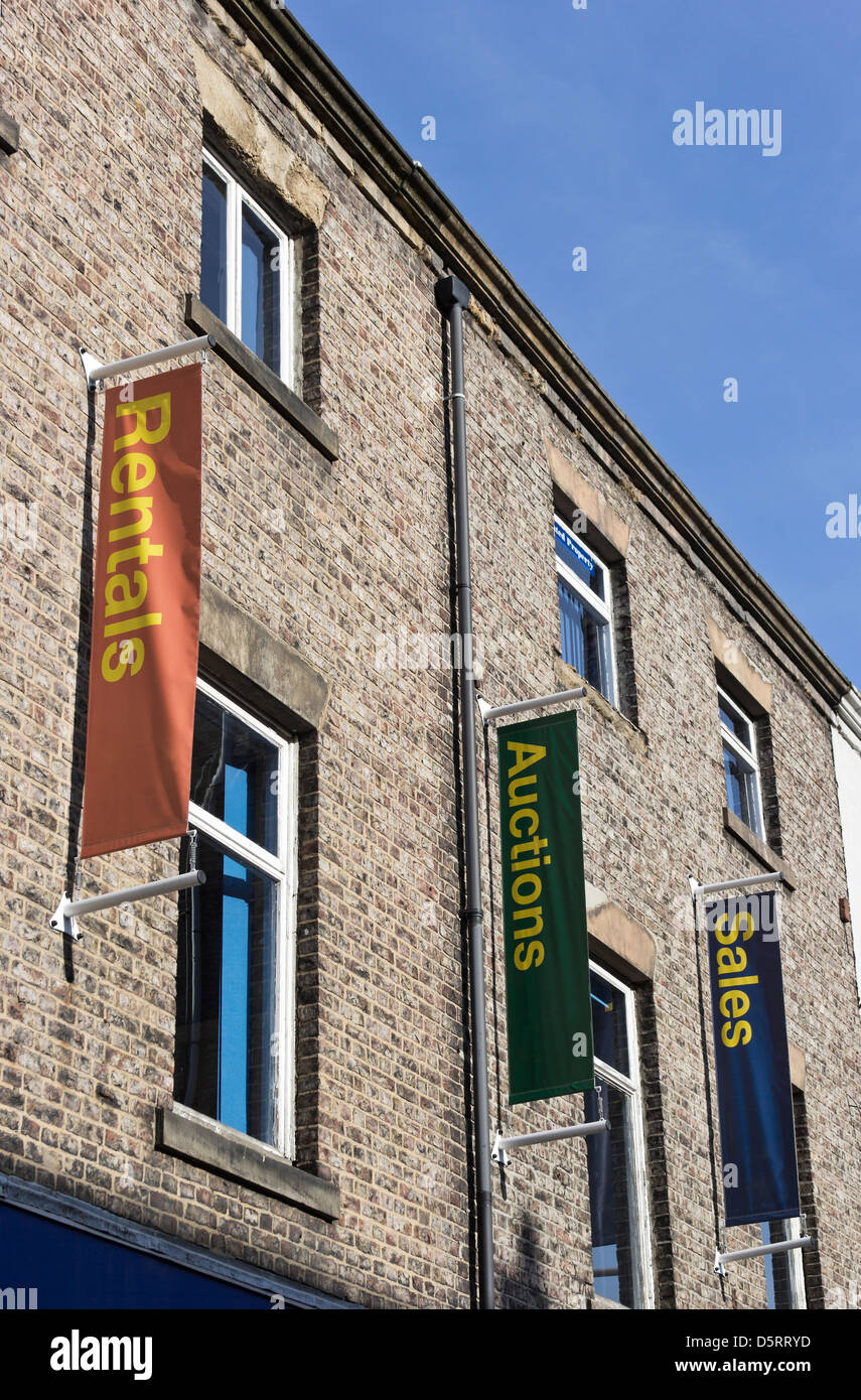 Building with pennants advertising property rental, auction and sales Stock Photo