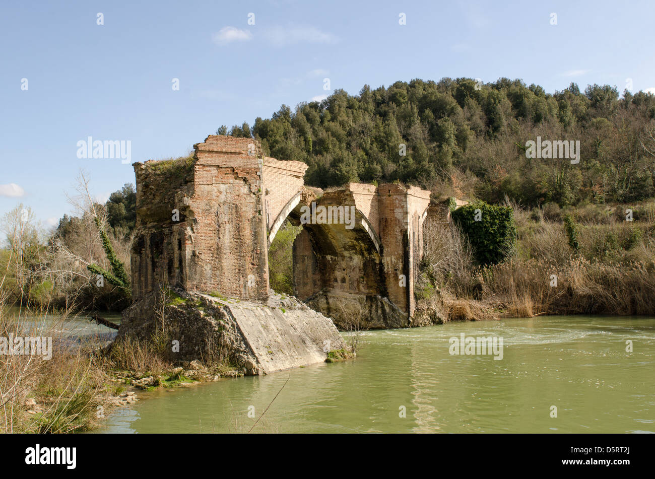 Ancient Medieval Bridge over a Creek in the Tuscany Countryside. Stock Photo