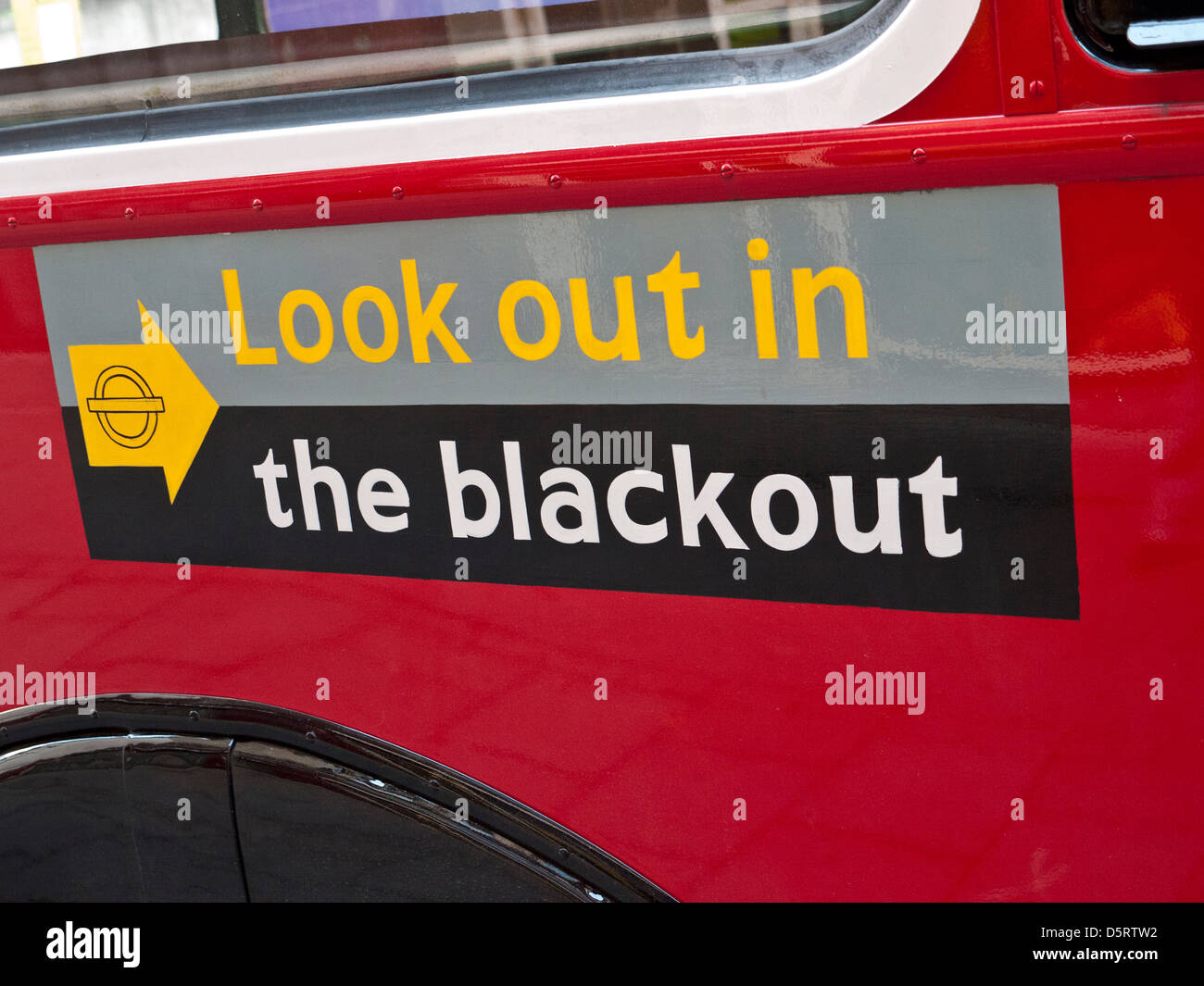 1940's vintage 'Look out in the Blackout' BLITZ WW2 Blackout sign on London red bus historic traditional red London bus with World War II poster Stock Photo