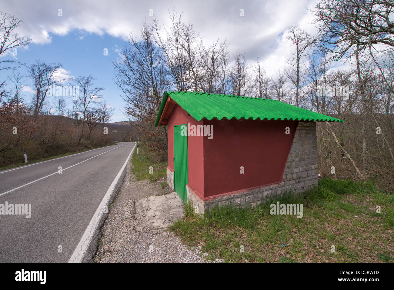 Wonderful Red and Green small house at the side of a Campaign Road. Stock Photo
