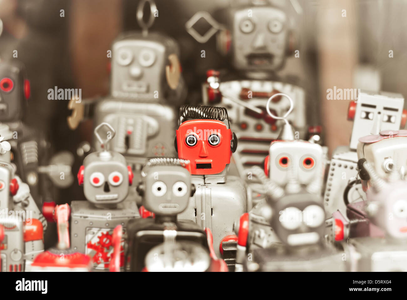 Single robot, standing out among the mass of robots Stock Photo