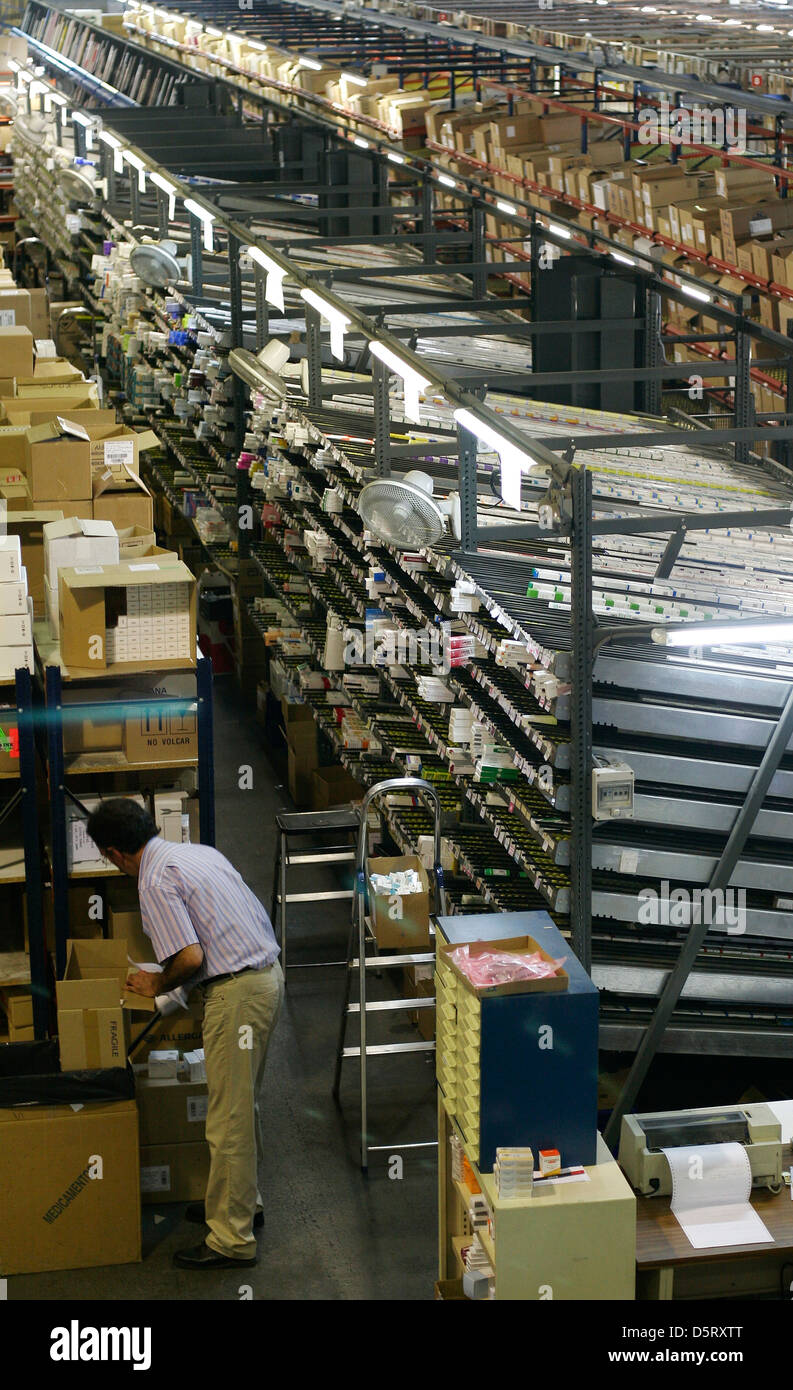 A worker stack boxes inside a pharmacy warehouse Stock Photo Alamy
