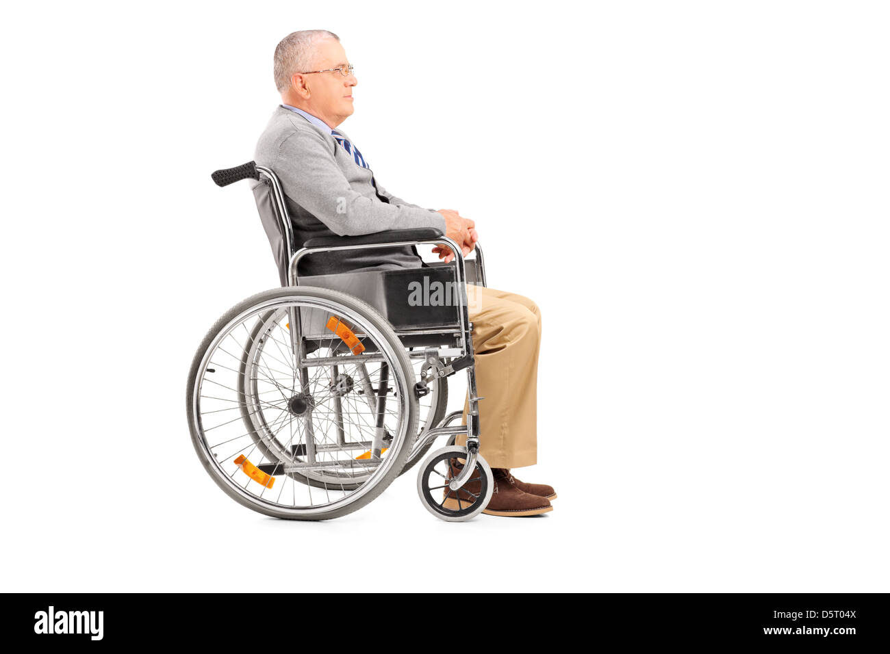 A disabled senior gentleman posing in a wheelchair isolated on white background Stock Photo