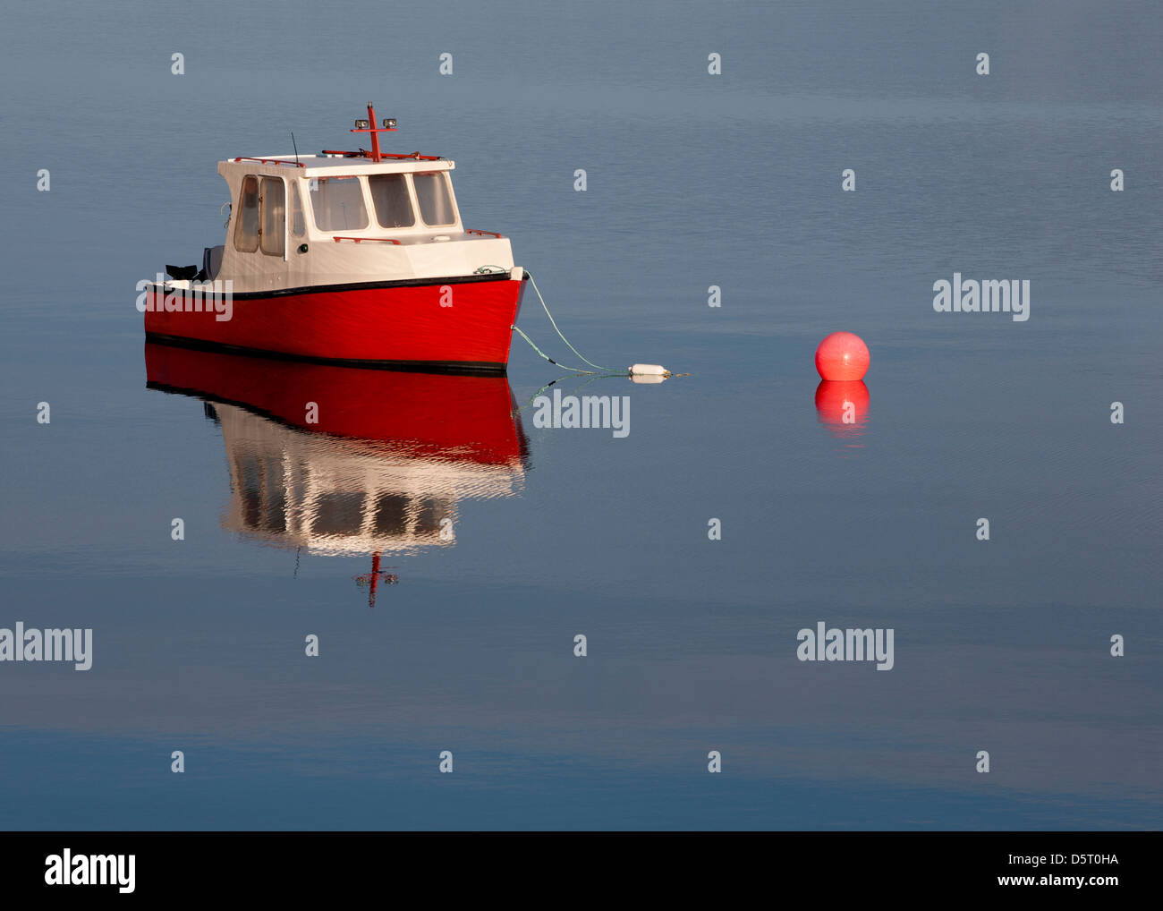 Small fishing boat on calm blue water Stock Photo - Alamy