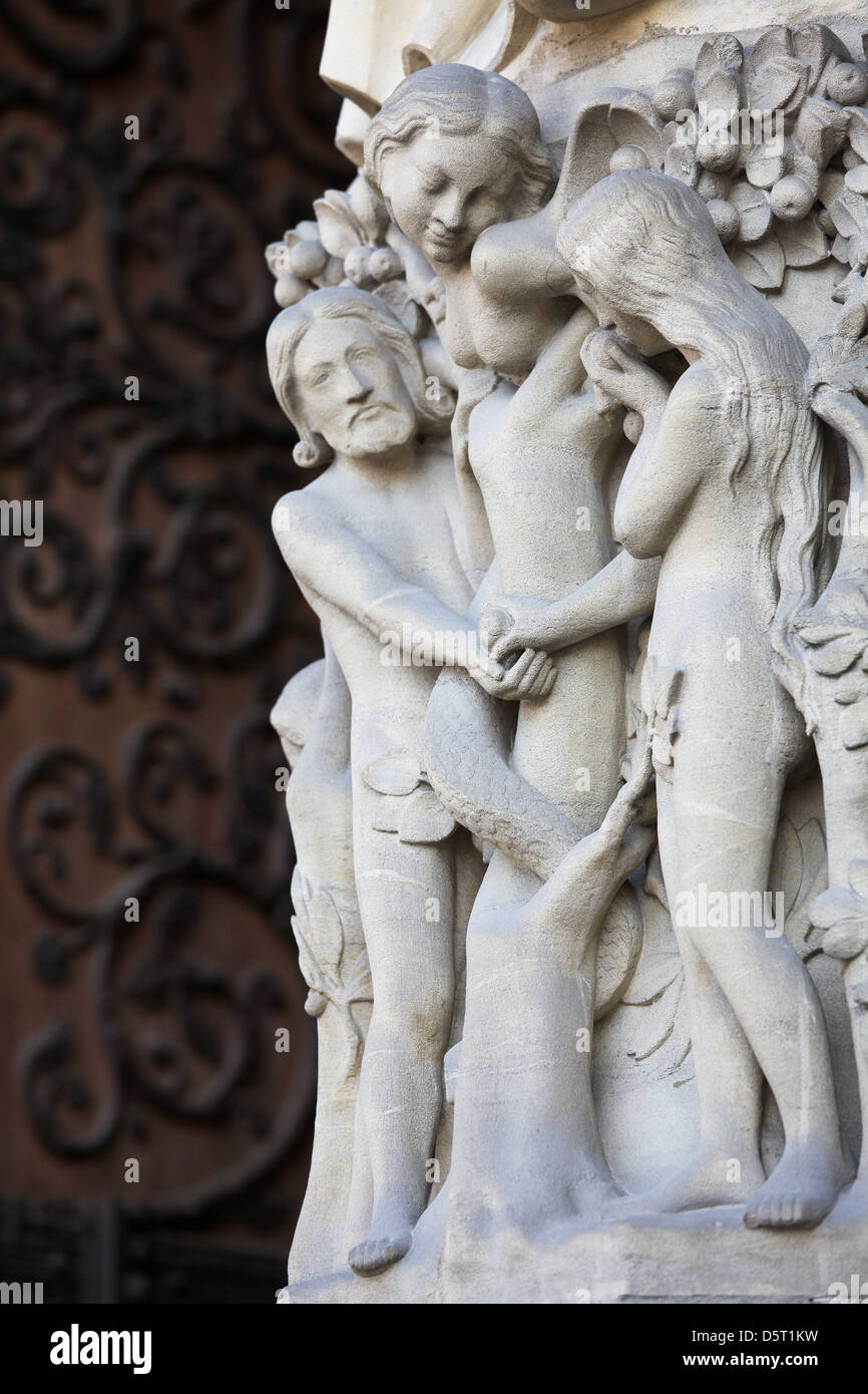 Adam and Eve eat the Forbidden Fruit at the Tree of Life in Paradise, sculpted at the Notre Dame Cathedral in Paris, France. Stock Photo