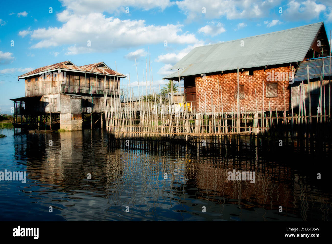 People live in simple houses made from wood and woven bamboo on Inle Lake Stock Photo