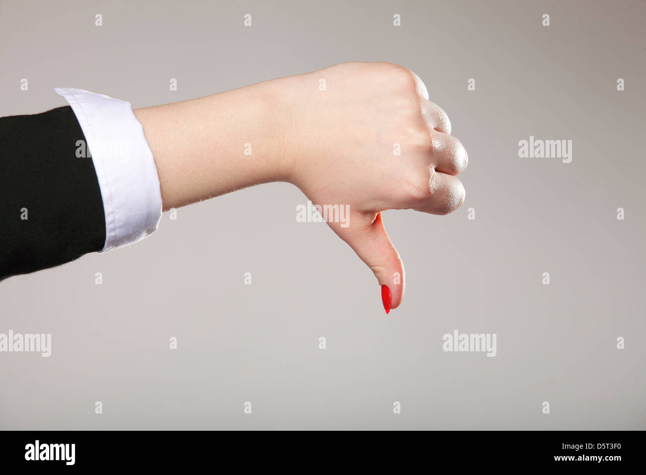 Business woman's thumb down hand sign gray background Stock Photo