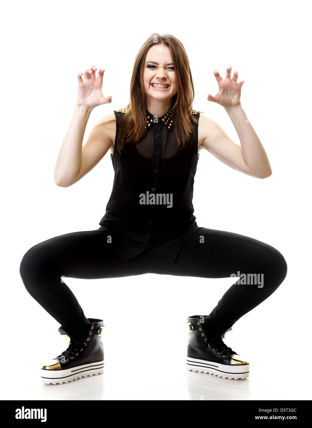 Grimacing. Full length young angry woman making silly face on white background Stock Photo