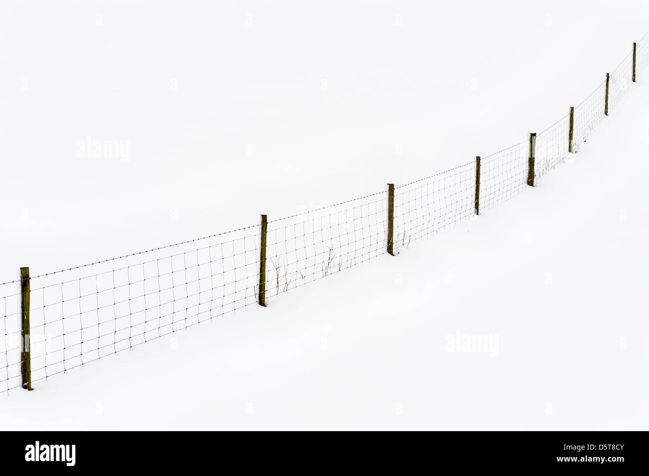 Snow-covered fields and fences in mid Wales make abstract patterns during the UK's cold spring of 2013 Stock Photo