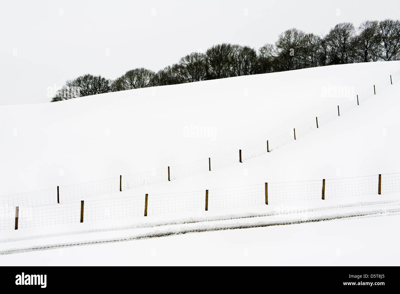 Snow-covered fields and fences in mid Wales make abstract patterns during the UK's cold spring of 2013 Stock Photo
