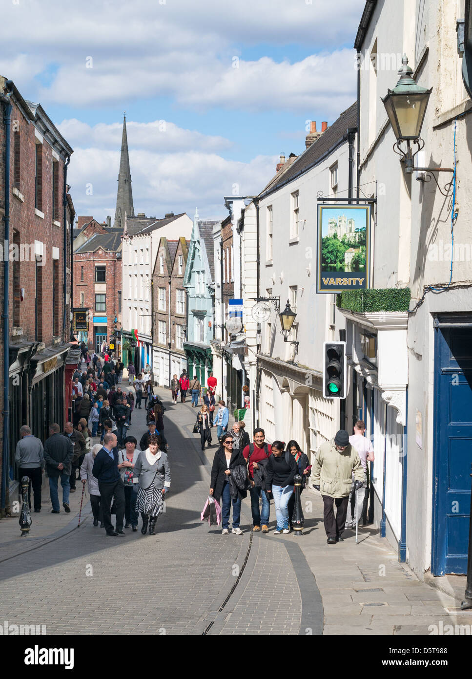 Tourists walking up Saddler Street Durham City north east England UK Stock Photo