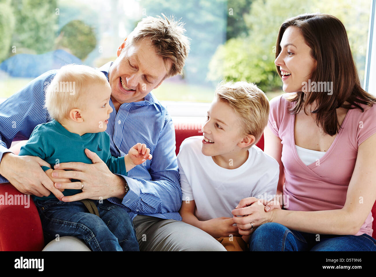 Family sat together at home Stock Photo