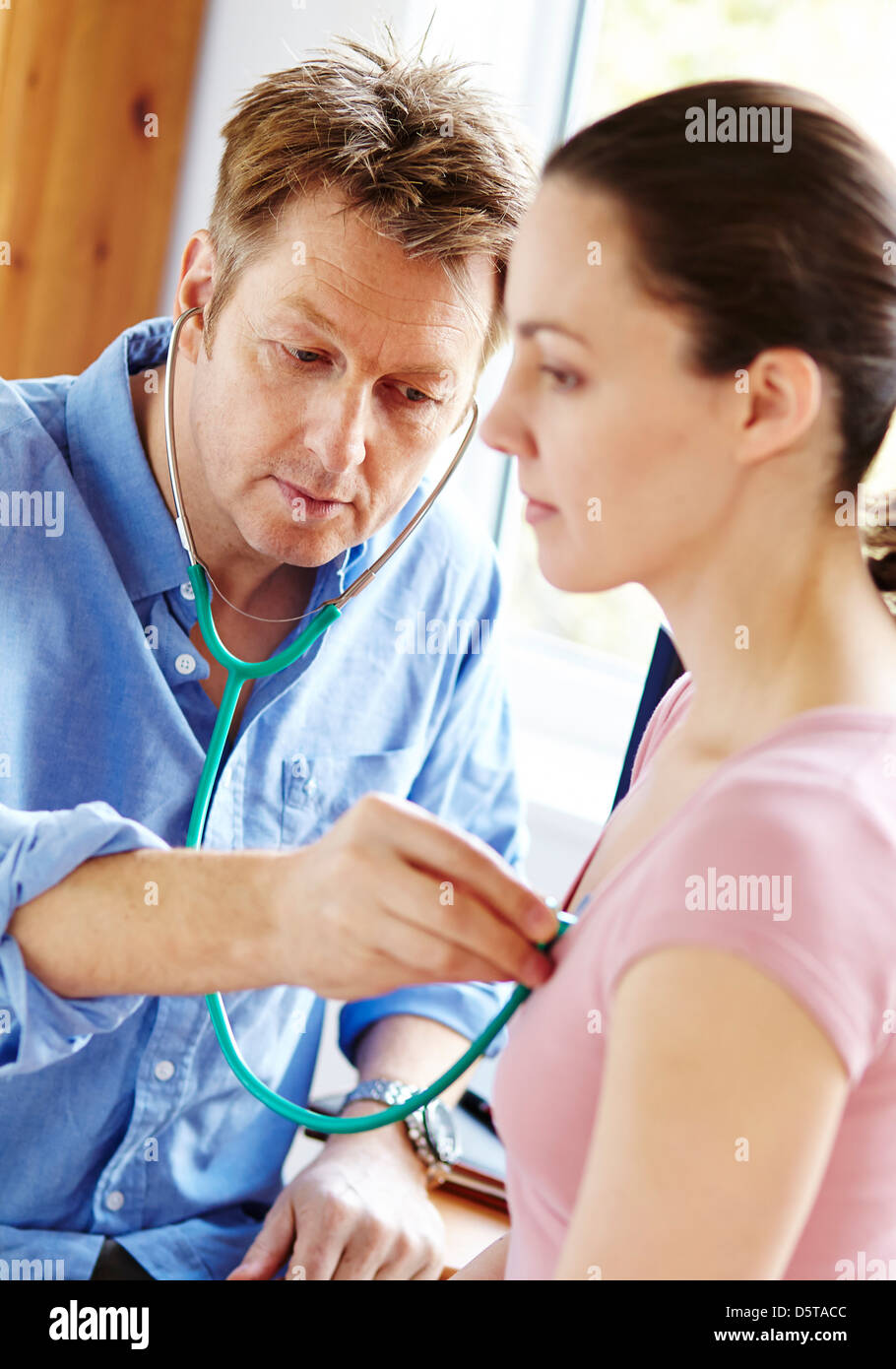 Doctor listening to patients chest Stock Photo