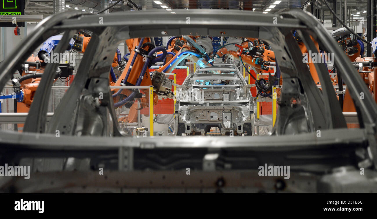 Welding robots assemble the body of the new Golf 7 at the VW plant in