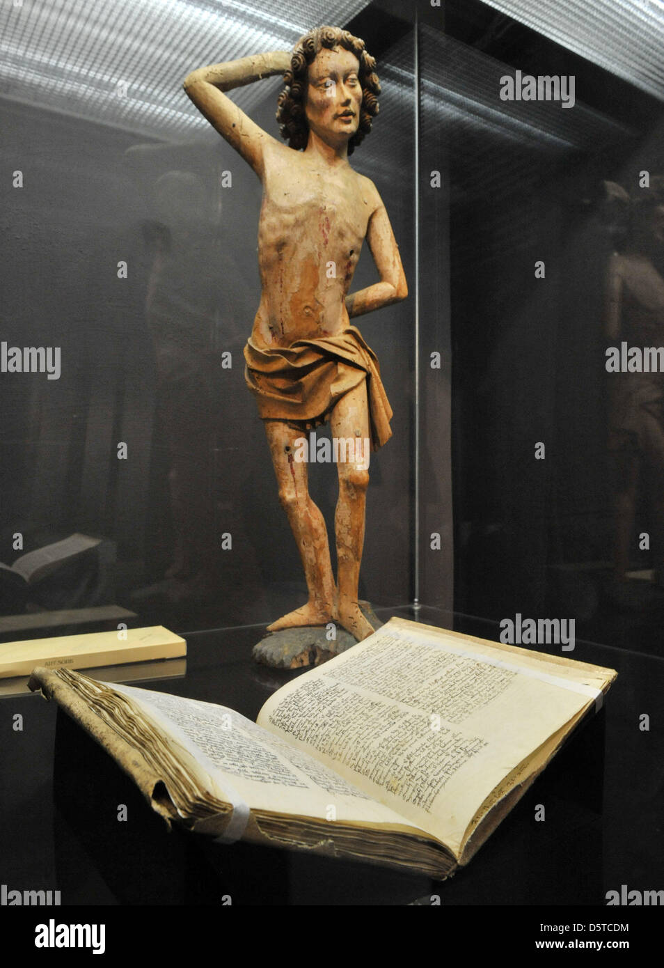A medical manuscript and a fragment of a statue of Saint Sebastian are on display at the Museum for Thuringian Regional Studies in Erfurt, Germany, 21 November 2012. An exhibition of the precious collection of manuscripts of scholar  Amplonius Rating de Berka (around 1365 - 1435) will take place from 24 November 2012 til 01 April 2013. The Bibliotheca Amploniana is considered the b Stock Photo