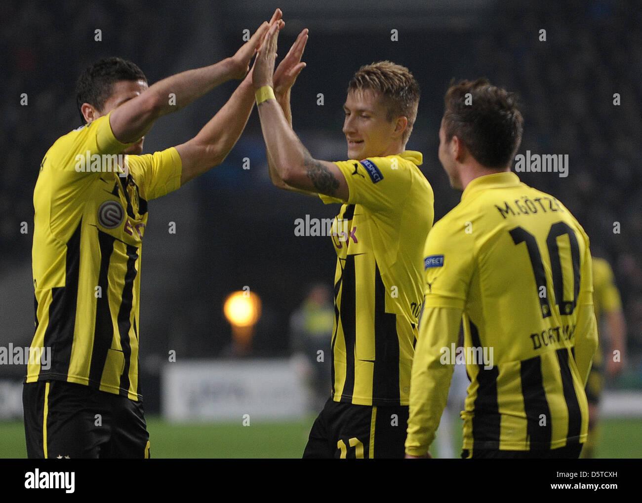 Dortmund's Robert Lewandowski (L-R), celebrates with teammates Marco Reus  and Mario Goetze after scoring the 0-4 during the UEFA Champions League  group D soccer match Ajax Amsterdam vs. Borussia Dortmund at the