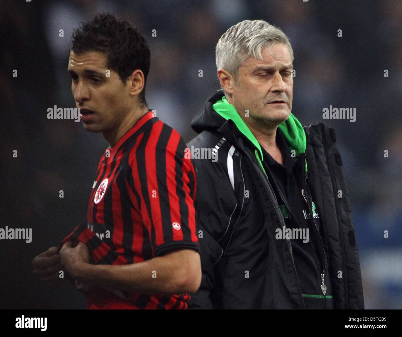 Frankfurt's head coach Armin Veh (R) closes his eyes next to his player Karim Matmour (L) after the German Bundesliga match between  FC Schalke 04 and Eintracht Frankfurt at VeltinsArena in Gelsenkirchen, Germany, 24 November 2012. Photo: FRISO GENTSCH  (ATTENTION: EMBARGO CONDITIONS! The DFL permits the further utilisation of up to 15 pictures only (no sequntial pictures or video- Stock Photo