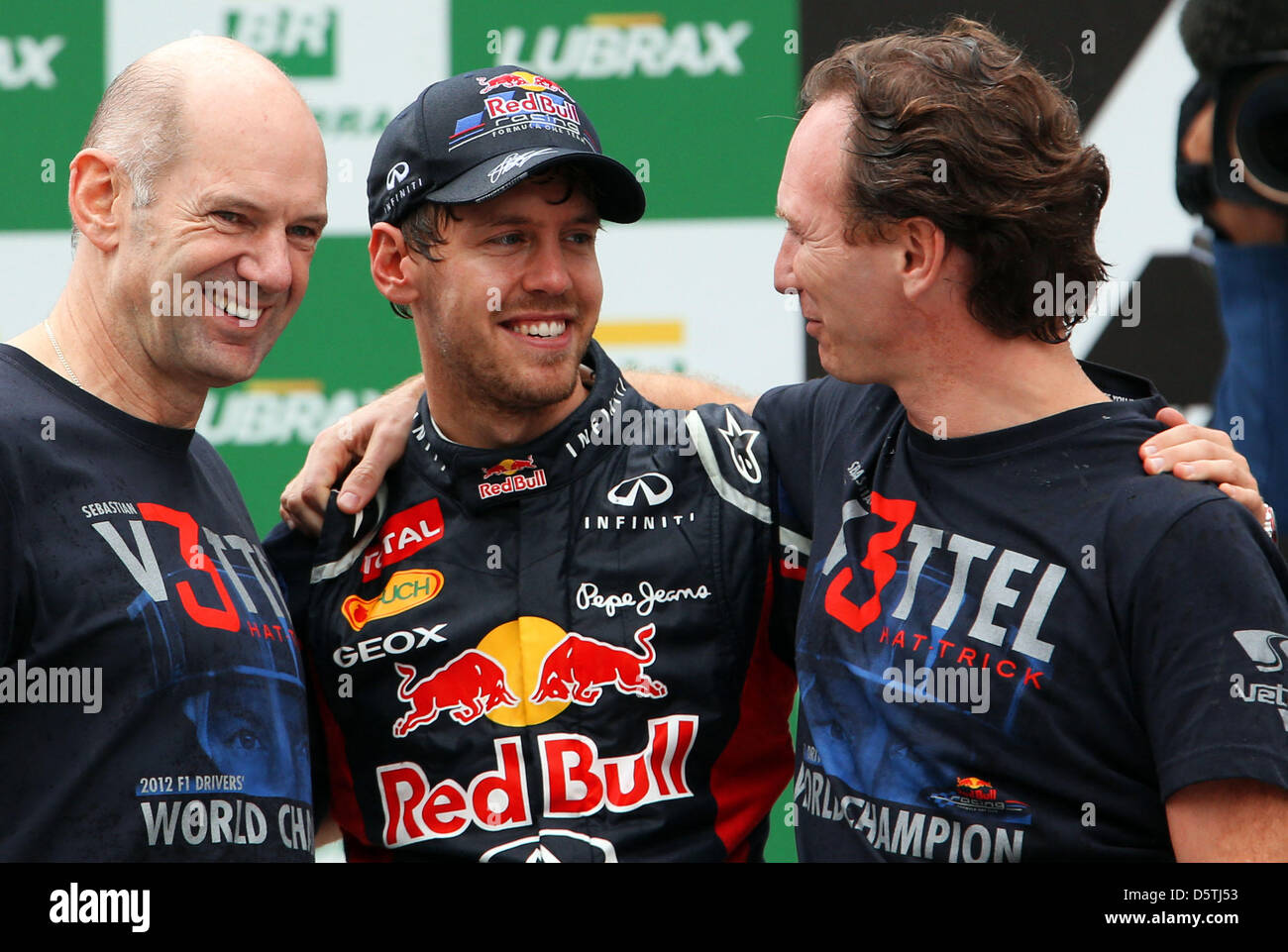 German Formula One driver Sebastian Vettel (C) of Red Bull celebrates his third world championship in a row with the team principal of Red Bull, British Christian Horner (R), and chief technical director of Red Bull, British Adrian Newey (L), after the Formula One Grand Prix of Brazil at Autodromo Jose Carlos Pace in Sao Paulo, Brazil, 25 November 2012. Photo: Jens Buettner/dpa  ++ Stock Photo