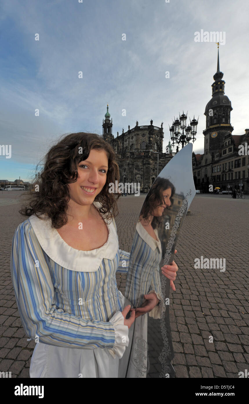 Stollen Maiden Cynthia Brozek shows a giant knife in front of the equestrian statue of King John in Dresden, Germany, 26 November 2012. The giant knife will be used to cut a three tons Stollen on 08 December 2012. PHOTO: MATTHIAS HIEKEL Stock Photo