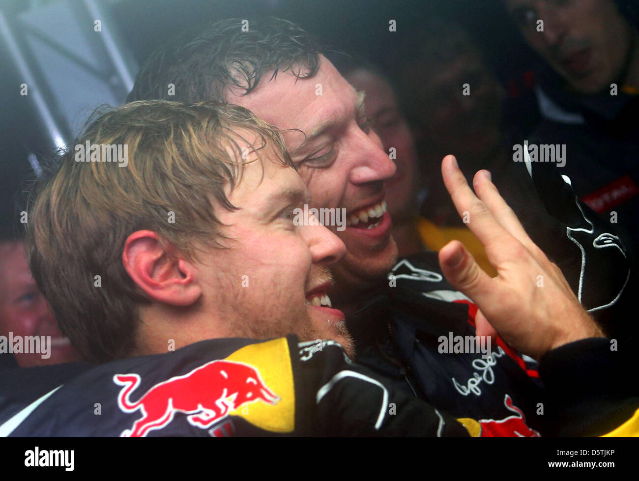 German Formula One driver Sebastian Vettel of Red Bull celebrates his third world championship in a row in the teamgarage after the Formula One Grand Prix of Brazil at Autodromo Jose Carlos Pace in Sao Paulo, Brazil, 25 November 2012. Photo: Jens Buettner/dpa  +++(c) dpa - Bildfunk+++ Stock Photo