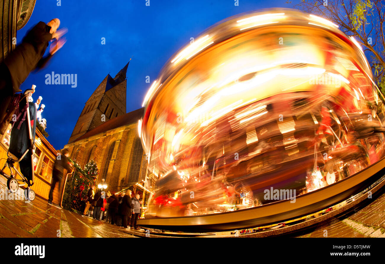 A merrygoround is pictured at the christmas market next to the market church in Hanover, Germany, 26 November 2012. Photo: Julian Stratenschulte Stock Photo