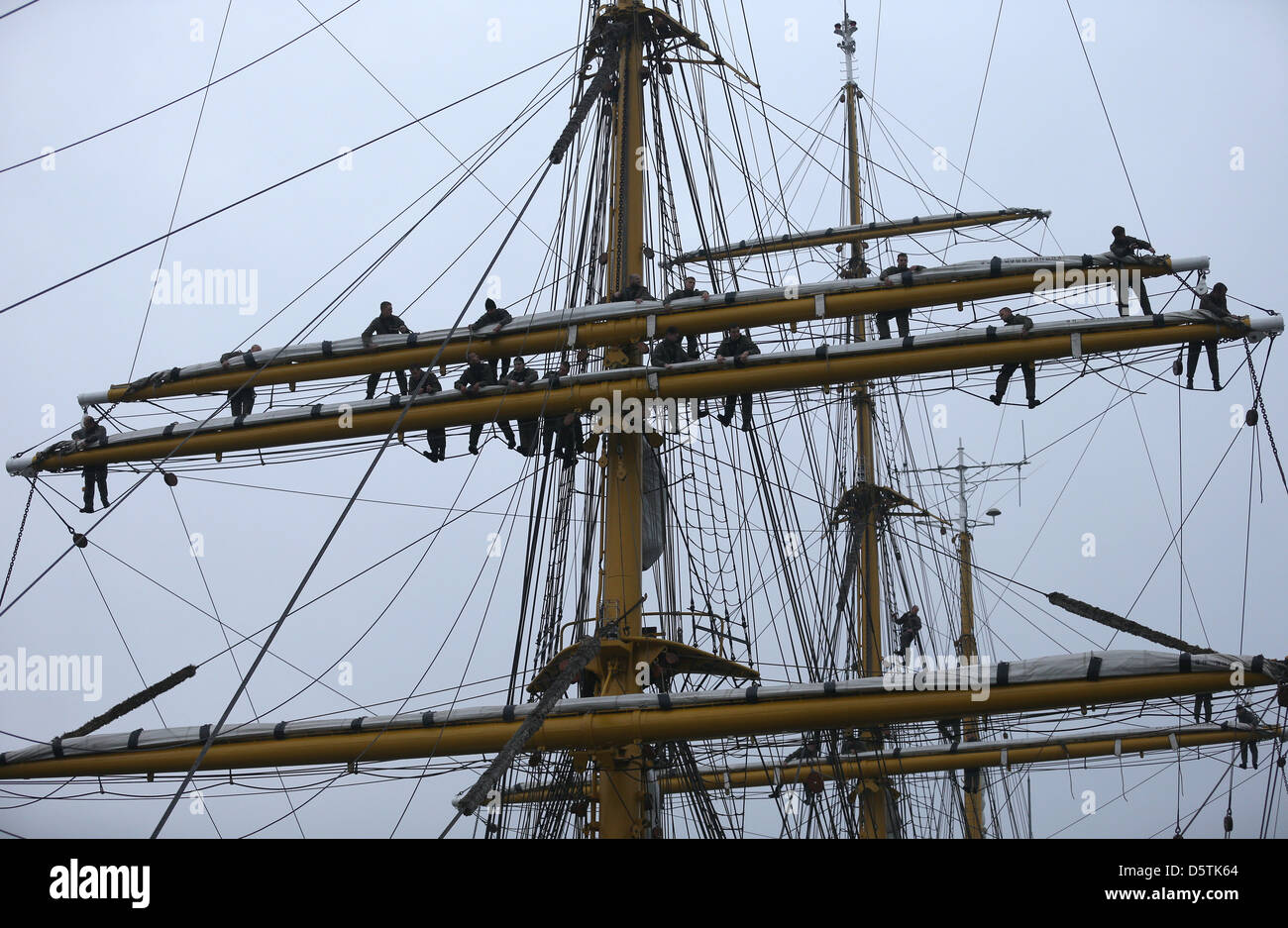 Sailors climb up the shrouds of the sail training ship of the German Navy, the 'Gorch Fock', as it leaves the naval port in Kiel, Germany, 27 November 2012. Two years after the training ship was forced to pause it now went on a trip with the new commander Risch. Photo: CHRISTIAN CHARISIUS Stock Photo