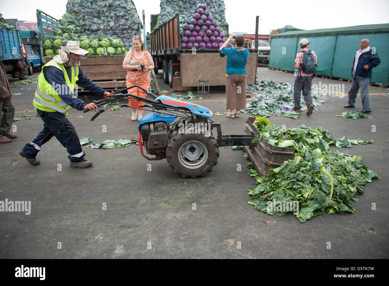Worker clearing out vegetables on the streets of Lo Valledor central wholesale produce market in Santiago, Chile Stock Photo