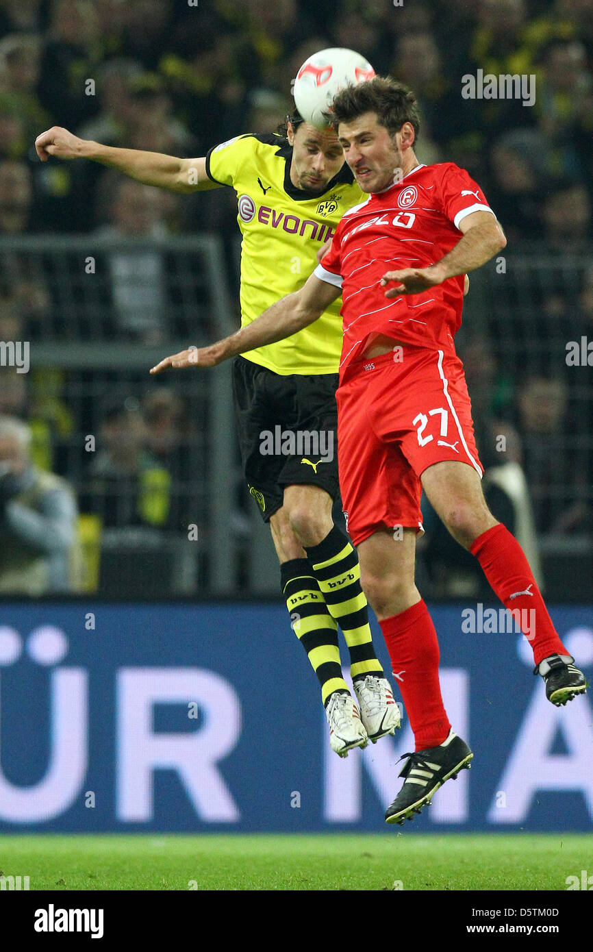 Dortmund's Neven Subotic (L) vies for the ball with Duesseldorf's Stefan Reisinger during the German Bundesliga match between Borussia Dortmund and Fortuna Duesseldorf at Signal Iduna Park in Dortmund, Germany, 27 November 2012. Photo: KEVIN KUREK (ATTENTION: EMBARGO CONDITIONS! The DFL permits the further utilisation of up to 15 pictures only (no sequntial pictures or video-simila Stock Photo