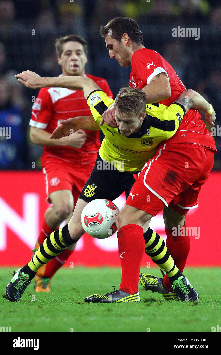 Dortmund's Marco Reus (front) vies for the ball with Duesseldorf's Ivan Paurevic during the German Bundesliga match between Borussia Dortmund and Fortuna Duesseldorf at Signal Iduna Park in Dortmund, Germany, 27 November 2012. Photo: KEVIN KUREK (ATTENTION: EMBARGO CONDITIONS! The DFL permits the further utilisation of up to 15 pictures only (no sequntial pictures or video-similar  Stock Photo