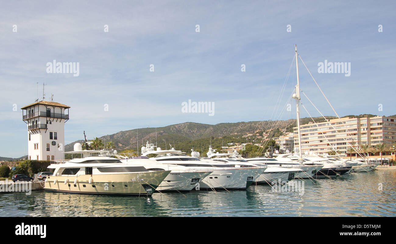 Scene with luxury motor yachts and capitaneria control tower in Puerto Portals marina, Calvia, South West Mallorca, Majorca. Stock Photo