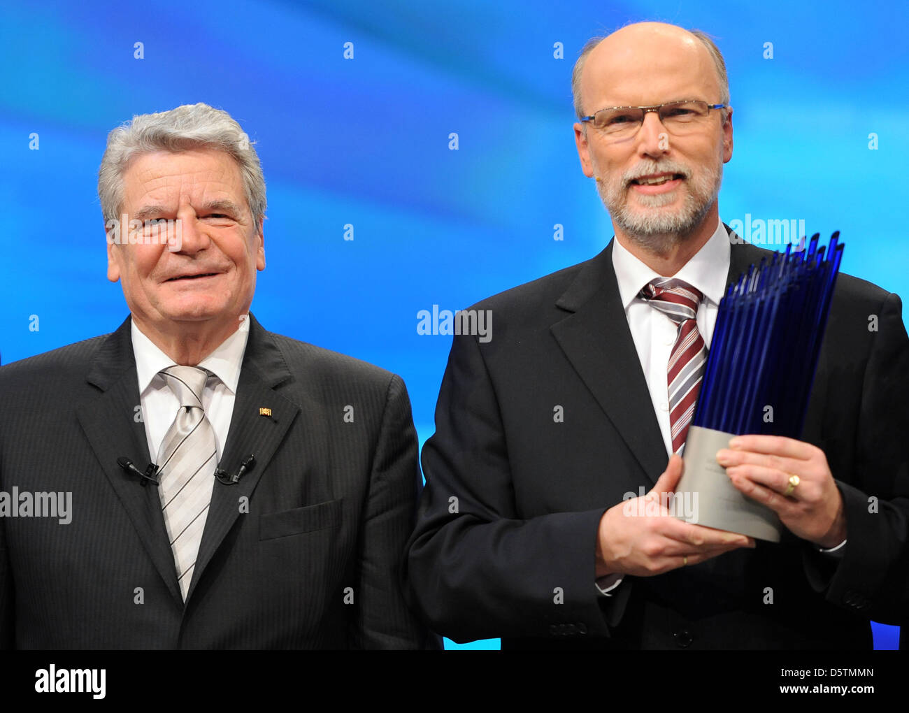 German Presdient Joachim Gauck (L) hands over the German Future Prize 2012 to physicist Birger Kollmeier in Berlin, Germany, 28 November 2012. The prize was awarded for binaural hearing aids which make possible spatial hearing. The prize has been awarded since 1997 and is endowed with 250,000 euro. It is awarded for outstanding techincal, engineering or scientific innovations. Phot Stock Photo