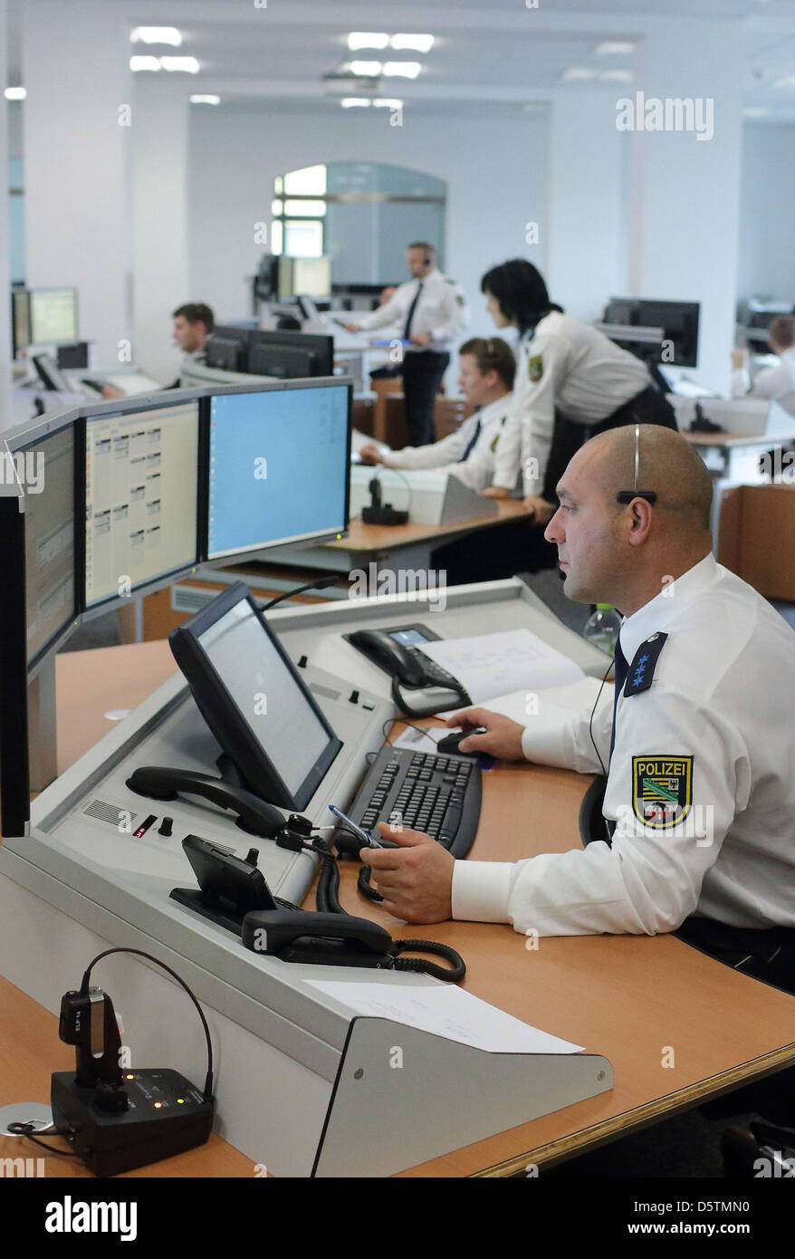 Police officers work in the new Police Operations Centre (LFZ) of police department Saxony-Anhalt North in magdeburg, Germany, 28 November 2012. The operations centre was inaugurated on the same day. the centre cost 5.3 million euro to build and is supposed to coordinate more effectively emergency calls from Magdebrg and six other administrative districts with a total of 1.16 milli Stock Photo