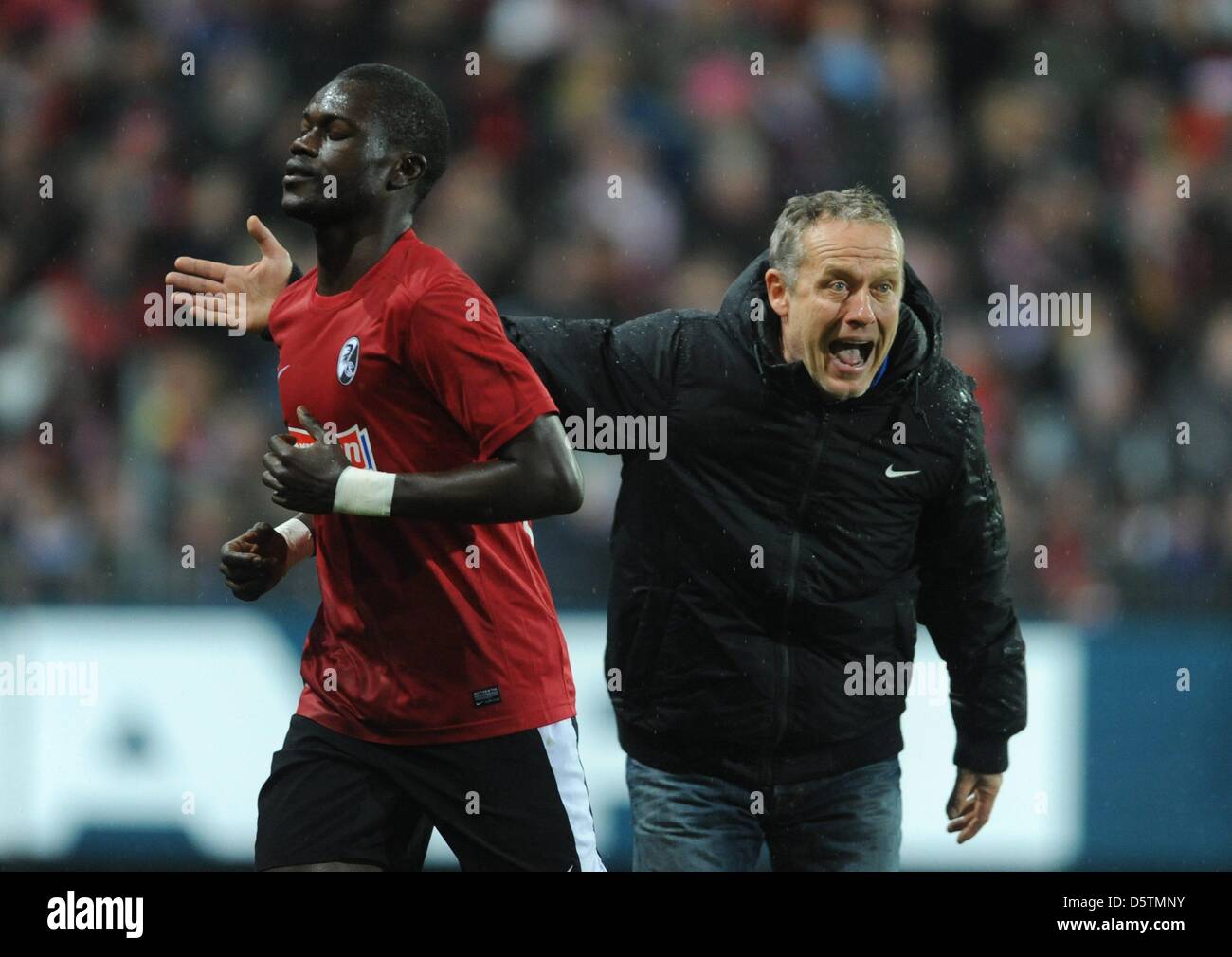 Freiburg's Daniel Caligiuri Fallou Diagne leaves the pitch after seeing the red card while his head coach Christian Streich proests during the Bundesliga soccer match between SC Freiburg and Bayern Munich at Mage Solar Stadium in Freiburg, Germany, 28 November 2012. Photo: PATRICK SEEGER  (ATTENTION: EMBARGO CONDITIONS! The DFL permits the further utilisation of up to 15 pictures o Stock Photo