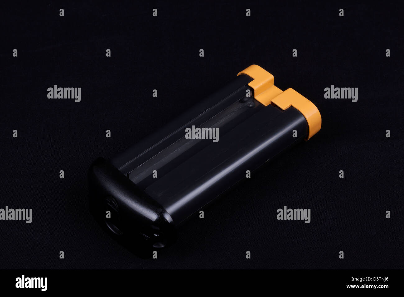 large style digital camera battery isolated on a black background Stock Photo