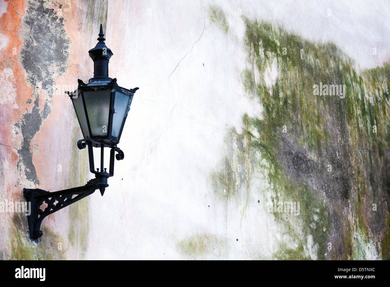 Old Lantern on a weathered wall in Tallinn, Estonia Stock Photo