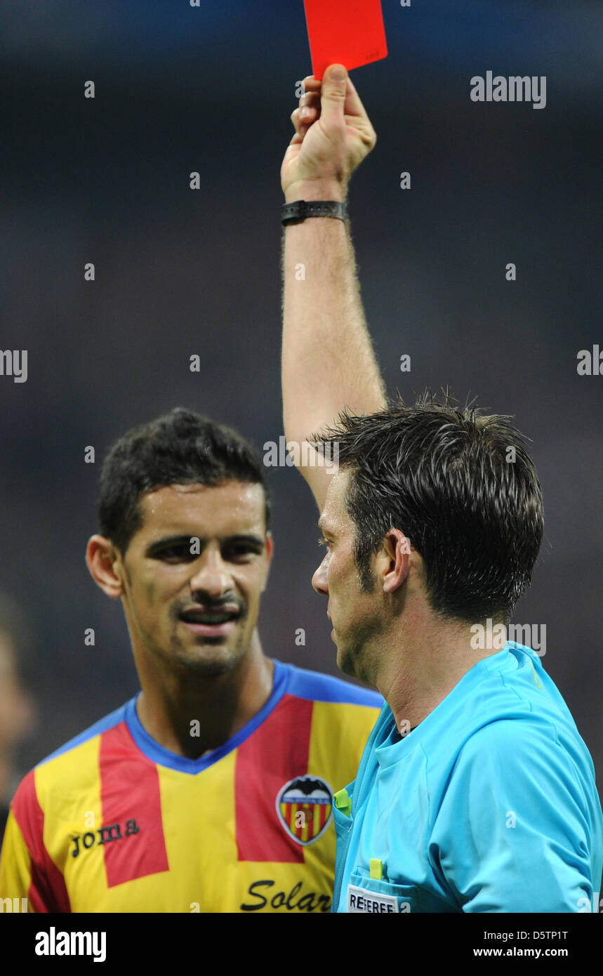 Valencia Rami Referee Firat Aydinus (R) shows the red card to Valencia's Adil Rami ...