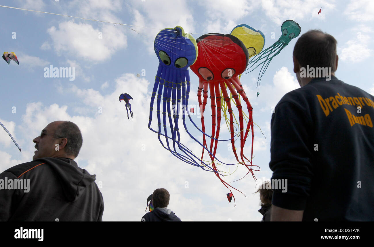 Visitors watch colourful kites at a kite festival on the former Tempelhof airport in Berlin