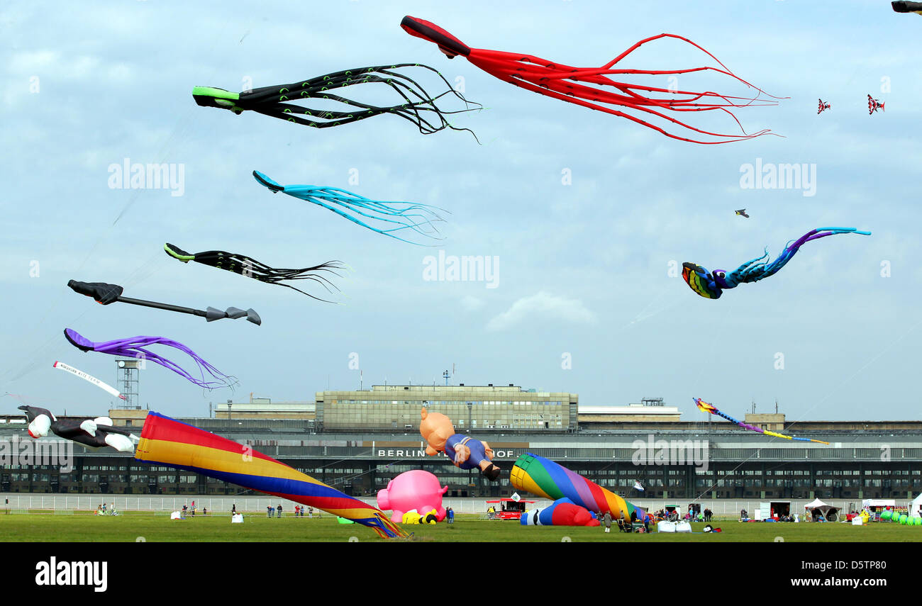 Visitors watch colourful kites at a kite festival on the former Tempelhof airport in Berlin